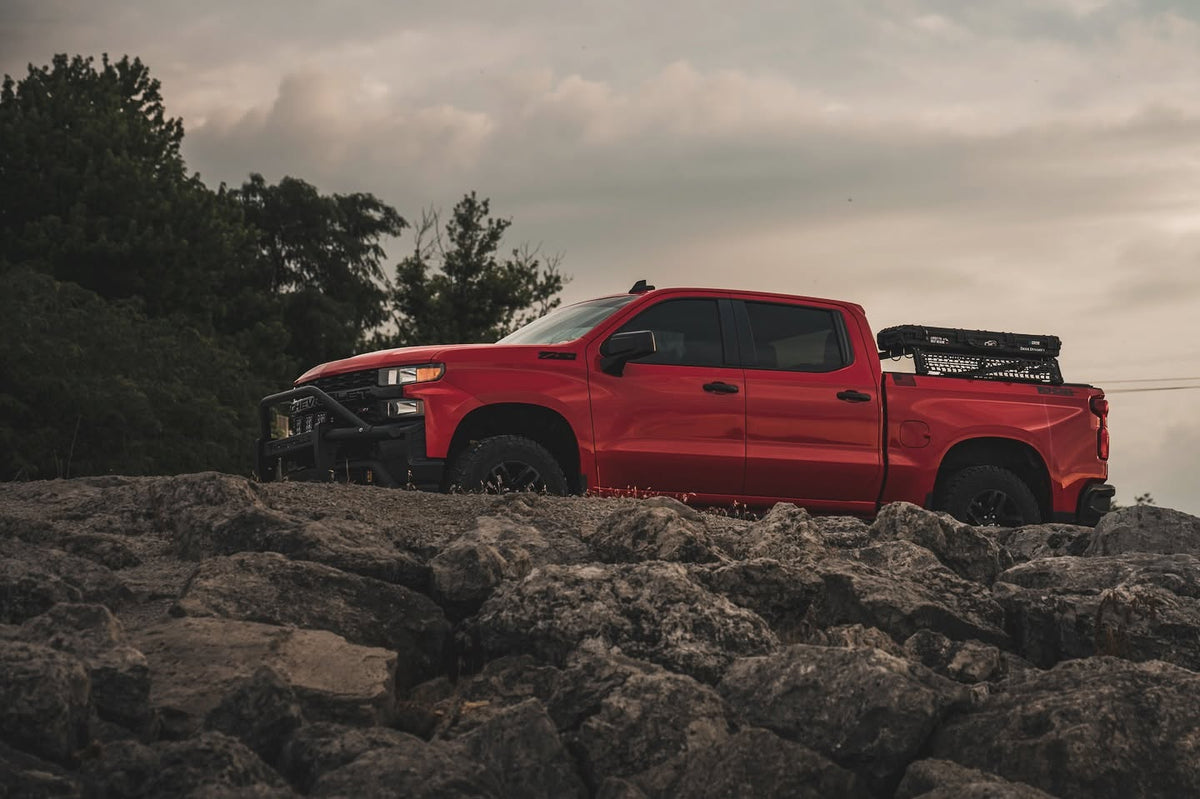 Side profile of a red Chevy Silverado 1500 Trail Boss with XBRS bed bars