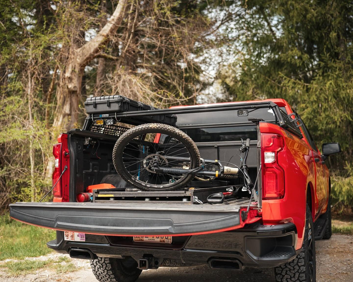 Bike in the bed under XBRS cross bars on a Chevy Silverado, tailgate down