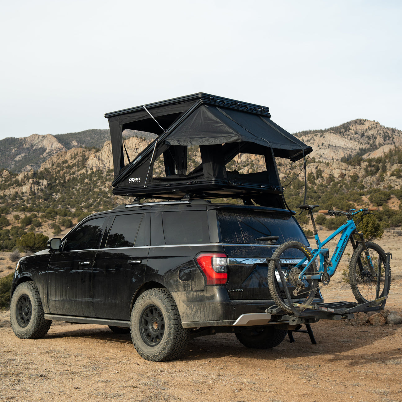 Open hard shell rooftop tent mounted on 4x4 roof rack