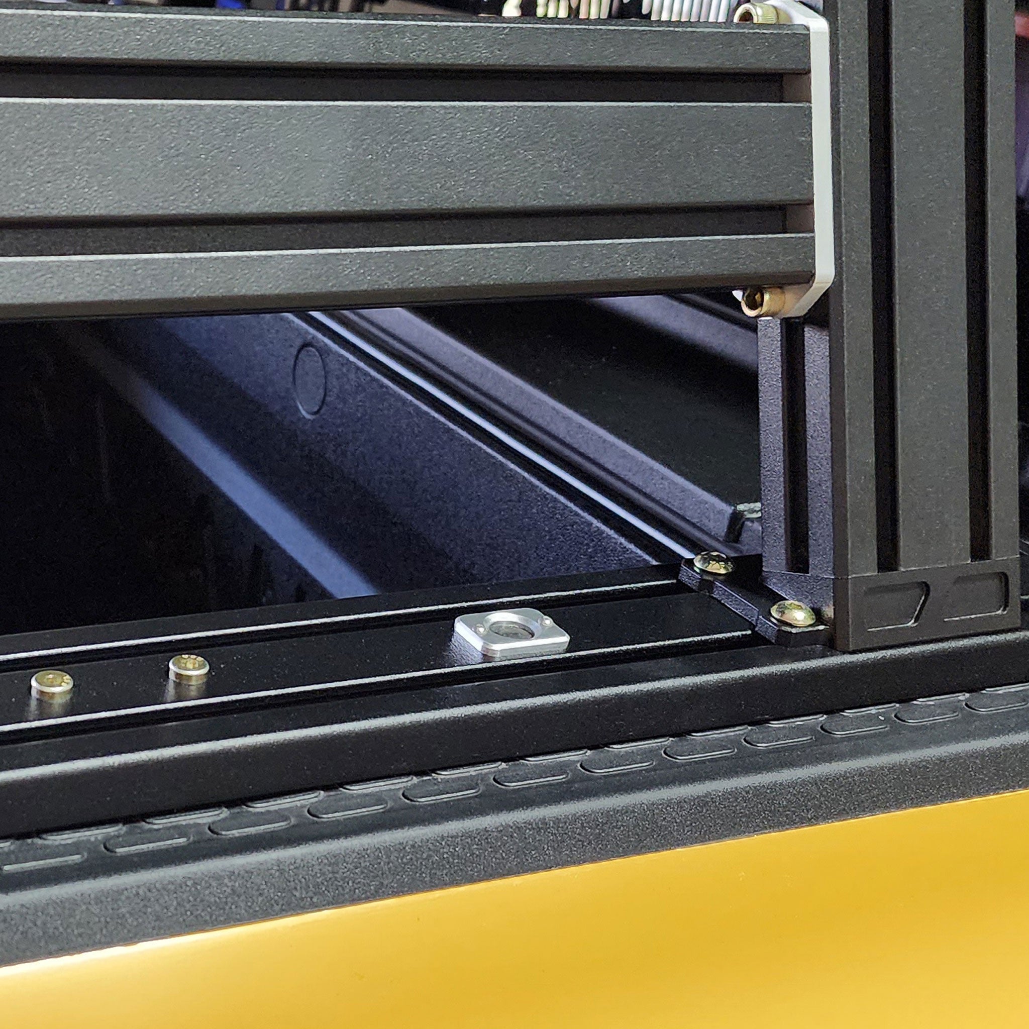 Rivian R1T XTR1 Bed Rack showing Gear Tunnel Button close up