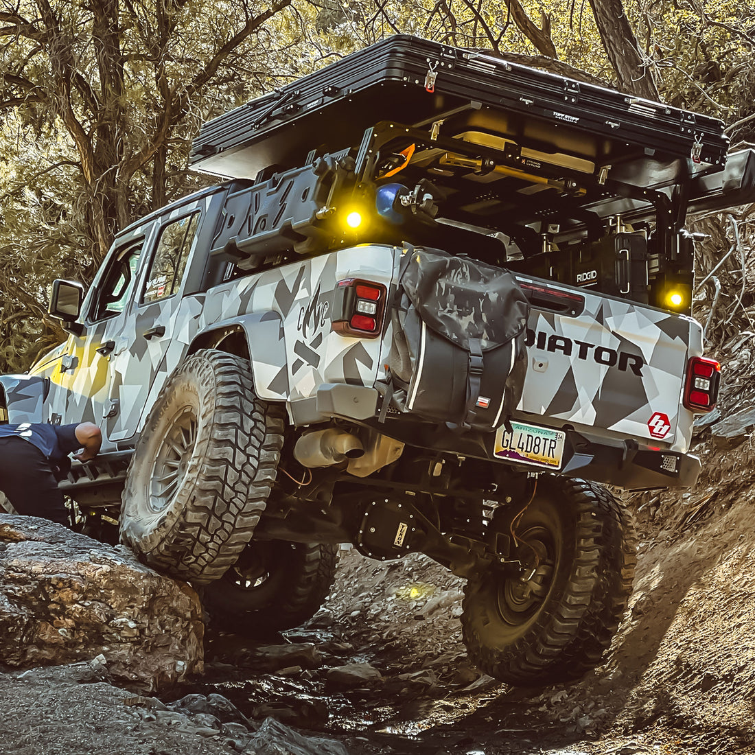 Image of Jeep Gladiator with 9 Degree XTR3 - 22 inch high bed rack, open roof top tent, Midnight Forest portable water storage tank, off-road.