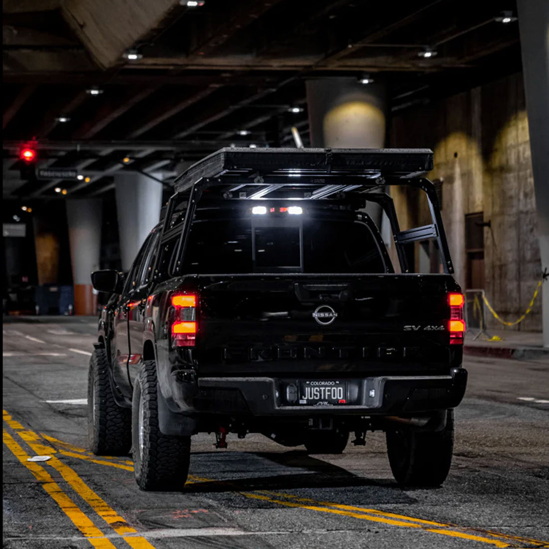 Nissan Frontier in urban setting with XTR1 Overland bed rack and roof top tent