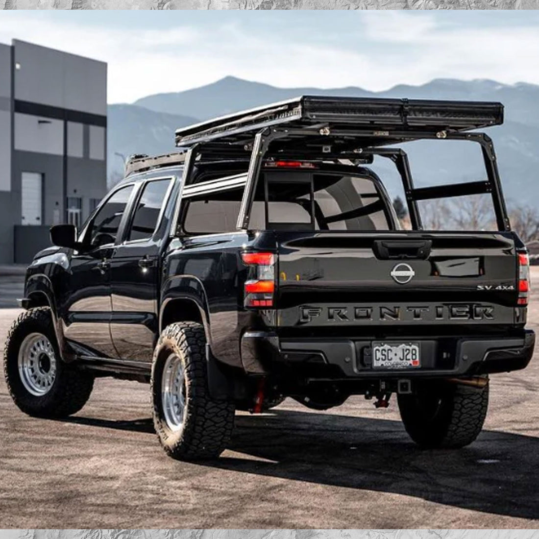 Nissan Frontier with XTR1 Overland bed rack and closed roof top tent