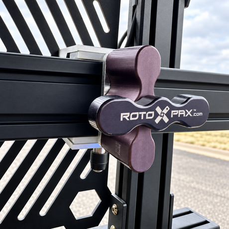 Close-up of the raw aluminum XTR Rotopax mounting plate with a Rotopax mount installed on a bed rack T-slot