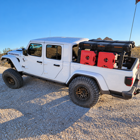 White Jeep Gladiator with red Rotopax fuel packs mounted on an XTR bed rack using the XTR Rotopax mounting plate