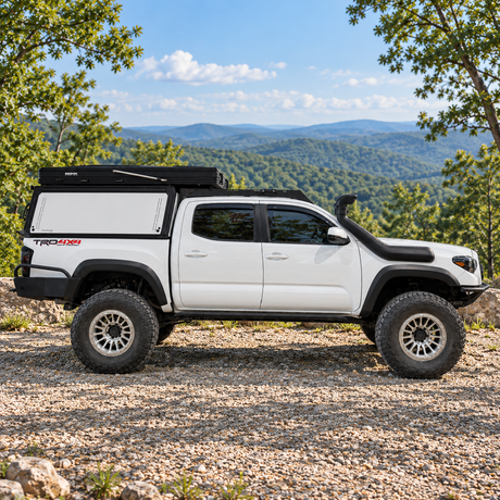 XOSKLTN truck topper cap in white on a Toyota Tacoma with roof top tent 