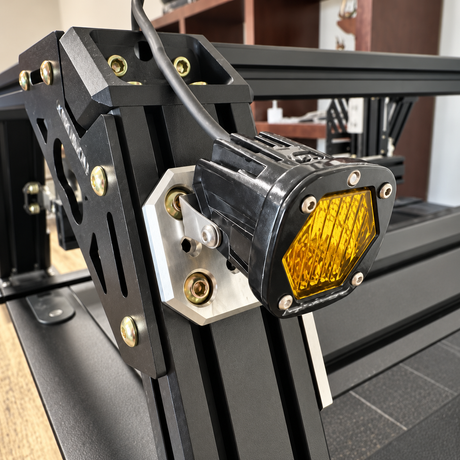 Universal center mounting plate with light attached to XTR bed rack and off road plate- Xtrusion Overland