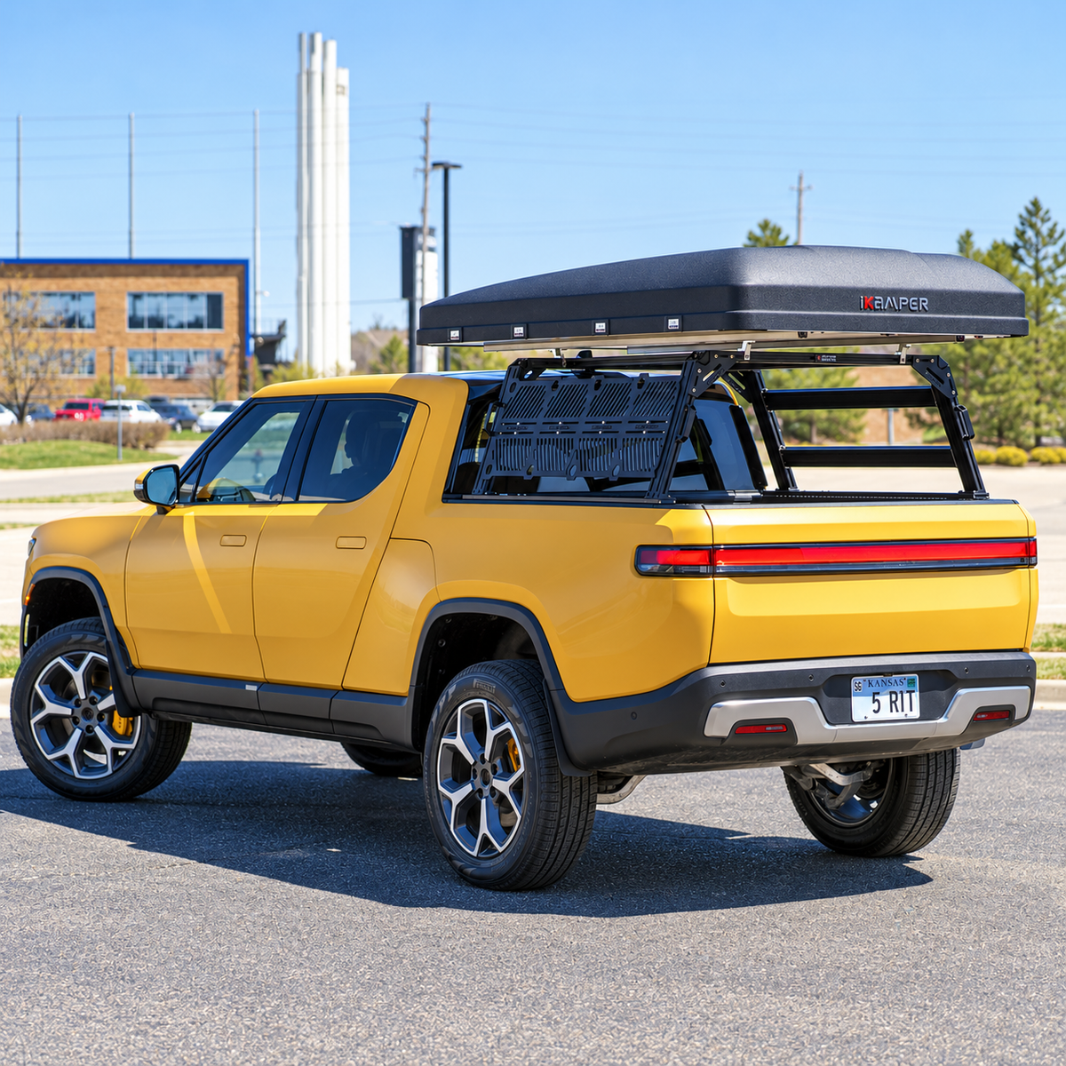Rivian with an XTR1 bed rack and extra side brace bars, molle plates and roof top tent