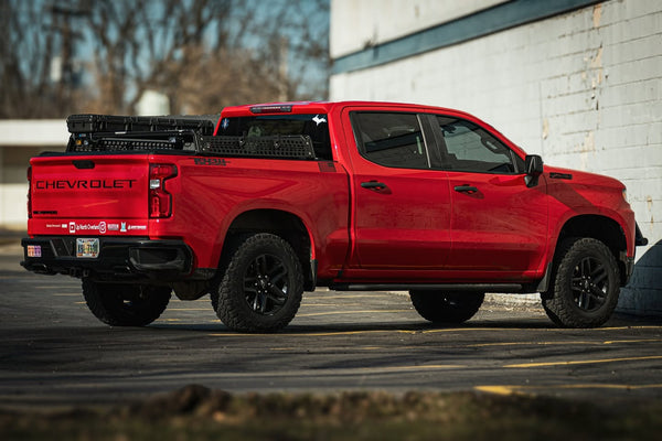 XBRS bed bars on a red Chevy Silverado 1500 Trail Boss, rear three-quarter view