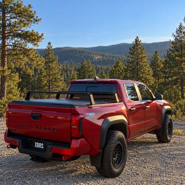 XBRS bed bars over a soft tonneau cover on a red 2024+ Toyota Tacoma, rear three-quarter view