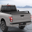 XBRS bed bars over a hard tonneau cover on a silver Nissan Titan, rear three-quarter view