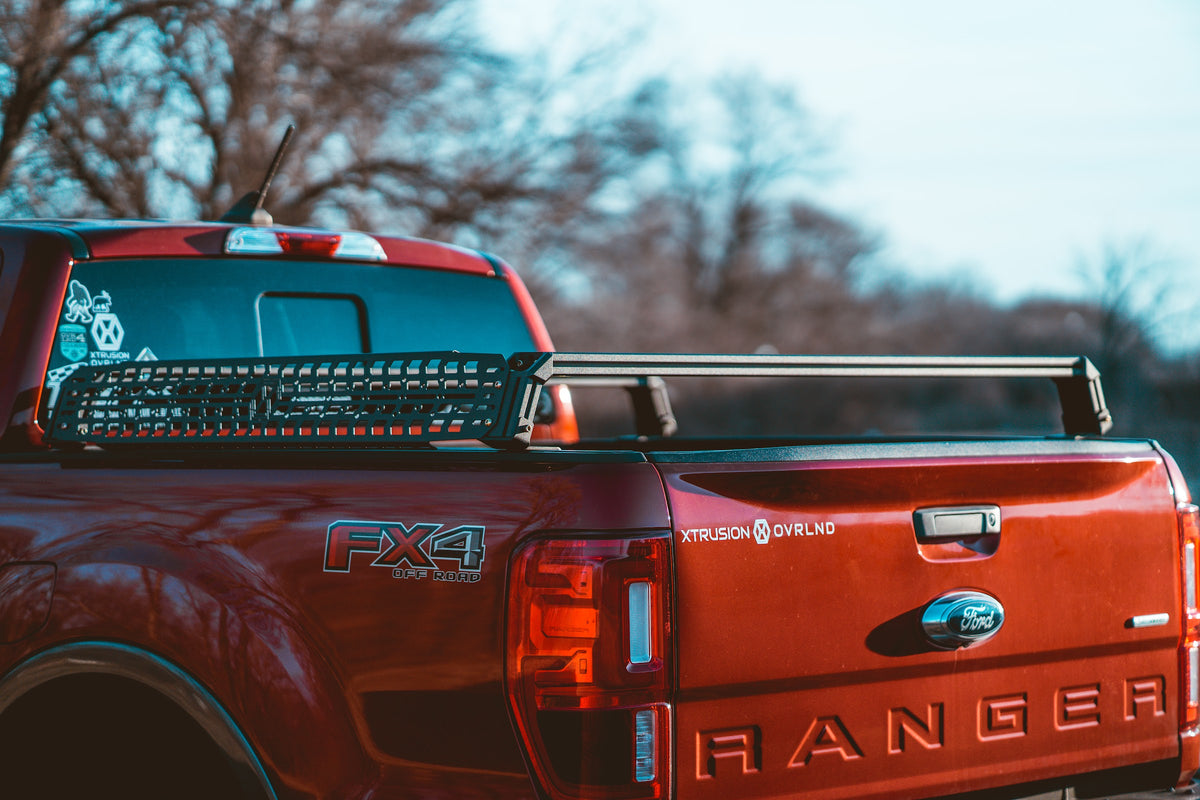 Tread MOLLE Plate mounted on the side of XBRS bed bars on a red Ford Ranger, rear view
