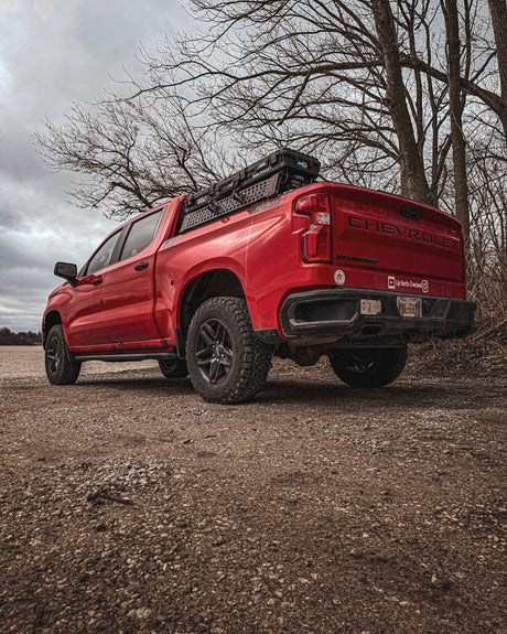 Red Chevy Silverado 1500 with XBRS truck bed cross bars, low rear angle