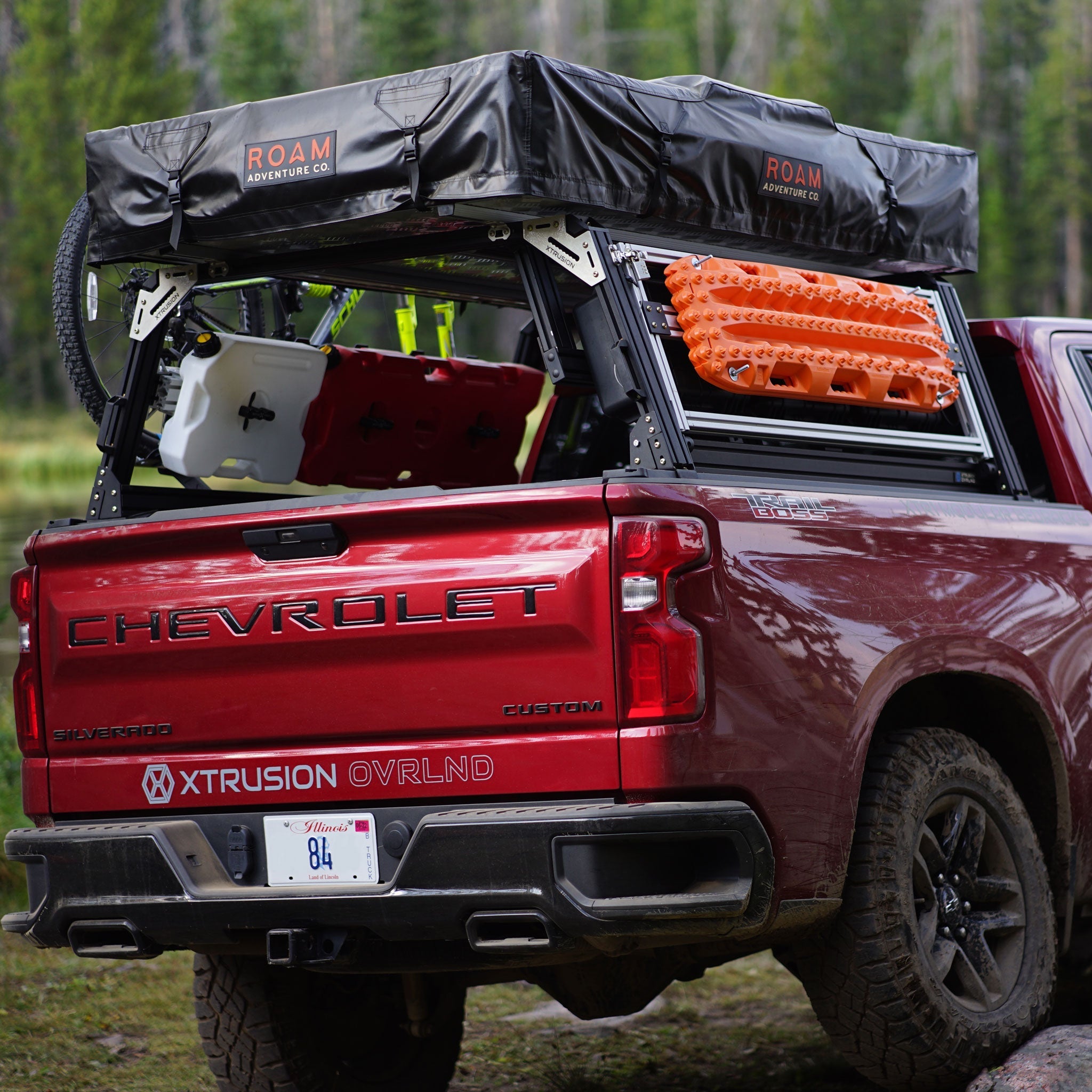 Chevy Silverado Extrusion Overland Bed Rack with traction boards, Rotopax, mountain bike, and roof top tent.