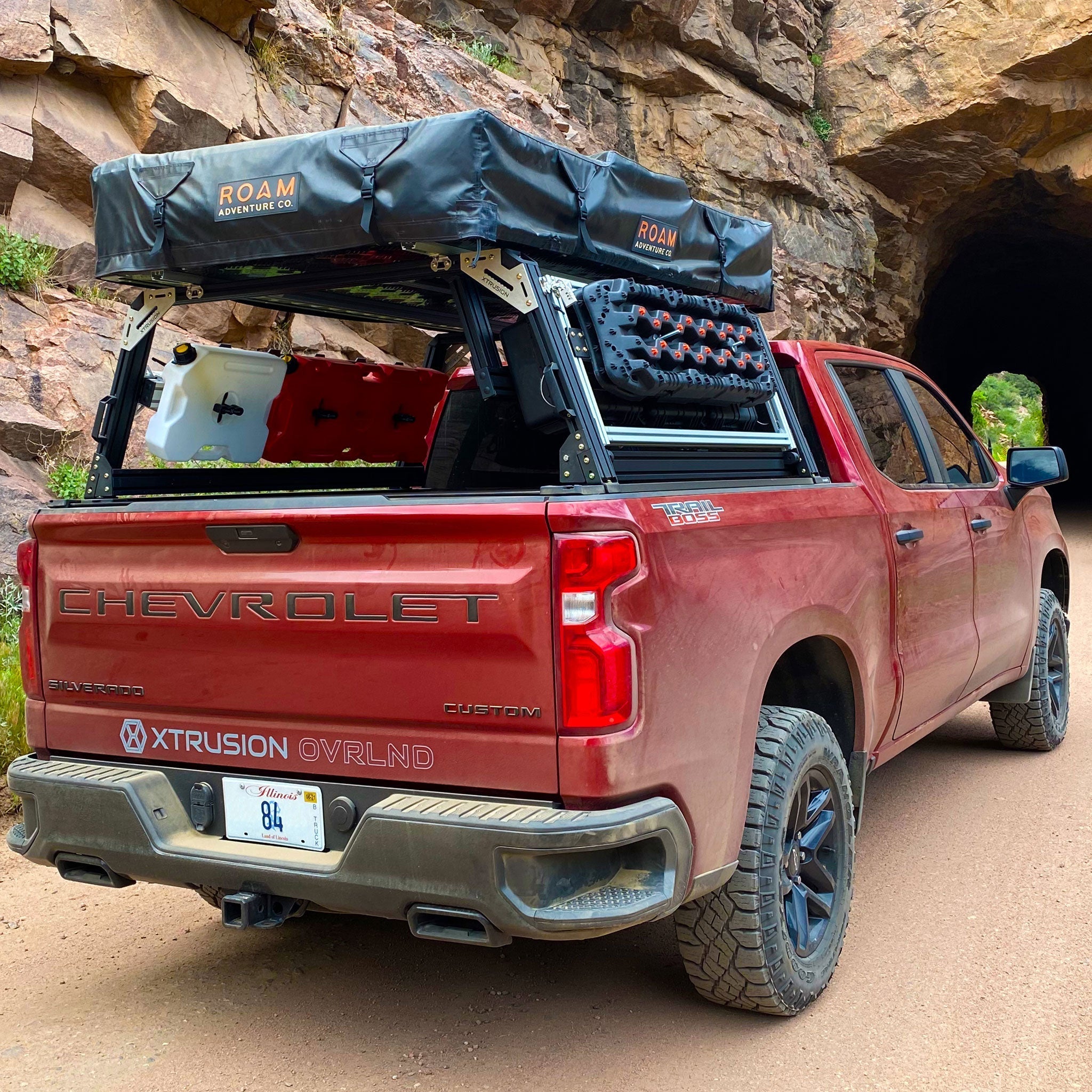 Chevrolet Silverado Extrusion Overland Bed Rack with traction boards, Rotopax, mountain bike, and roof top tent.