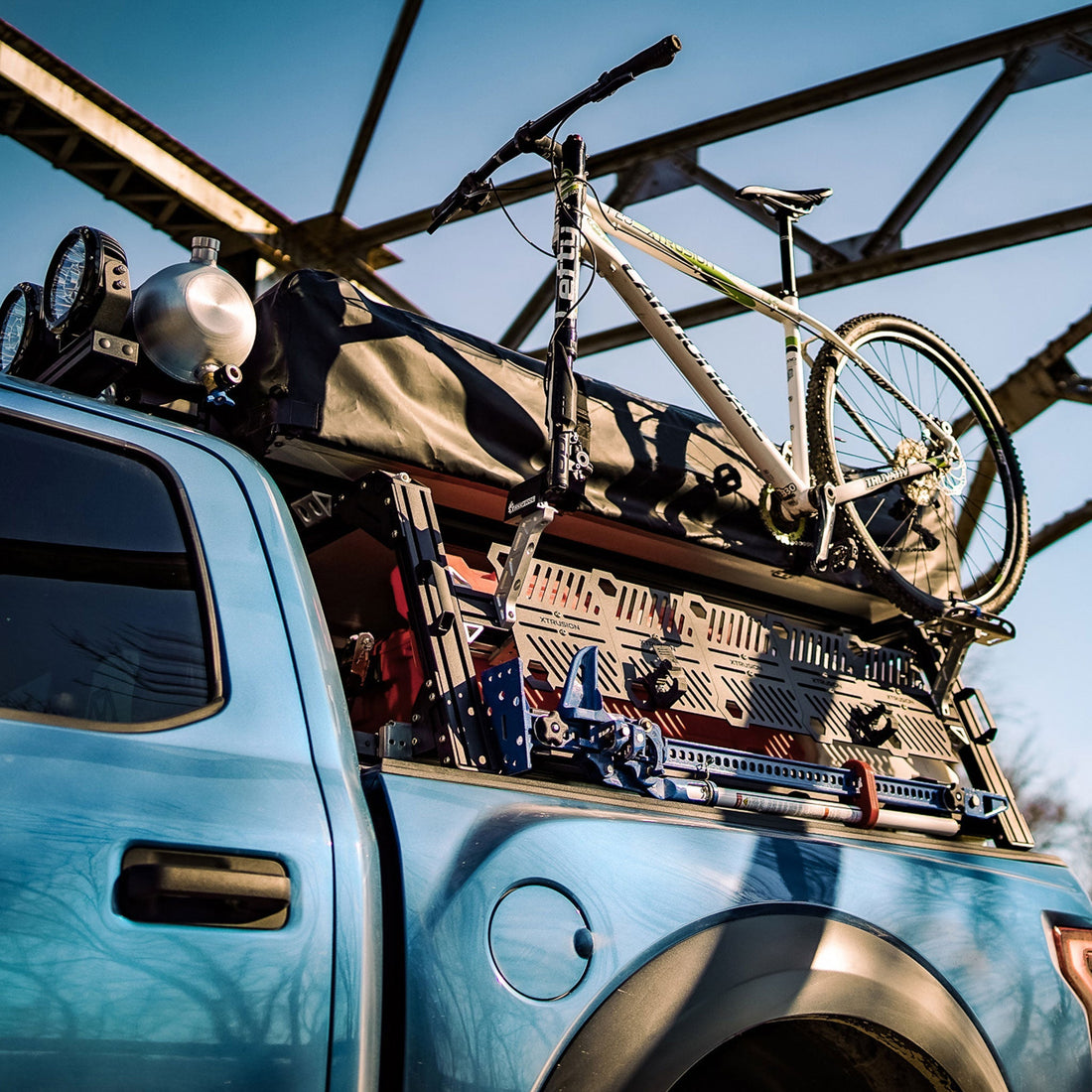 Ford Raptor Extrusion Overland Bed Rack with Hi-lift mounted, Rotopax’s mounted, Molle panels, Mountain Bike, Roof top tent, and Pressurized solar water tank.