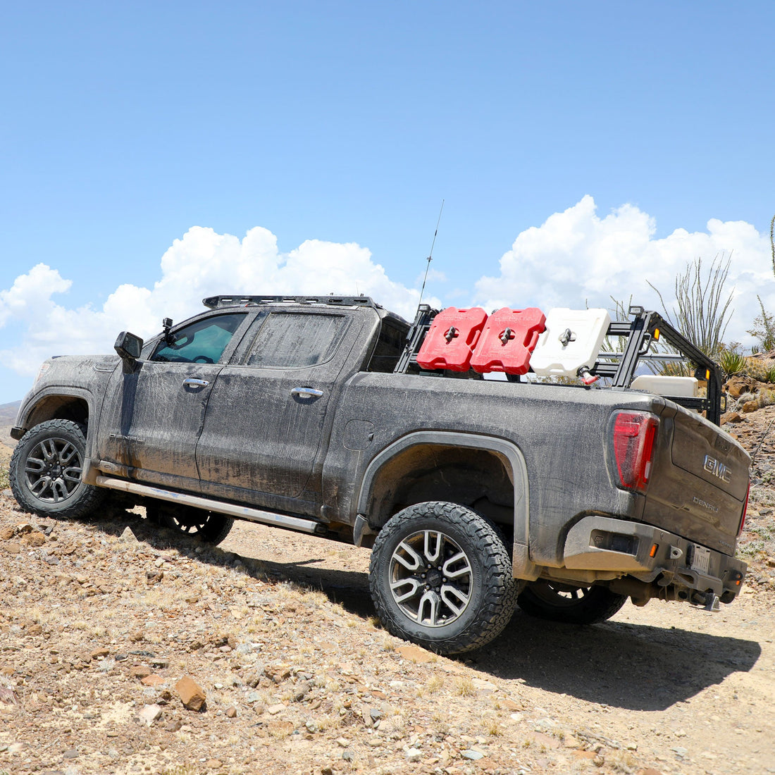 GMC Denali Sierra Extrusion Overland Bed Rack with RotoPax, WeBoost antenna, overlanding gear, and Off-road lights.