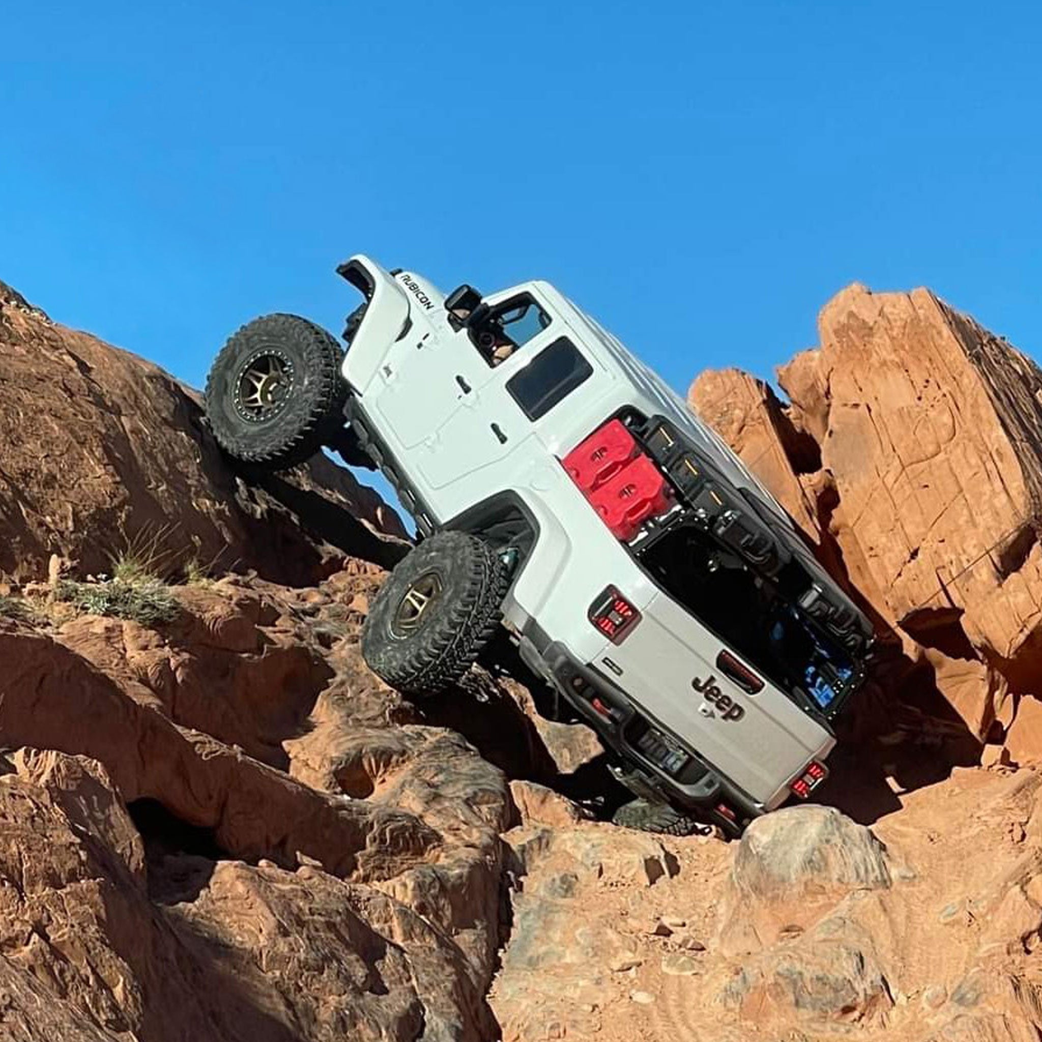 Rock climbing Jeep Gladiator Rubicon with XTR1 Bed Rack, RotoPax, Vault cases, and traction boards.  