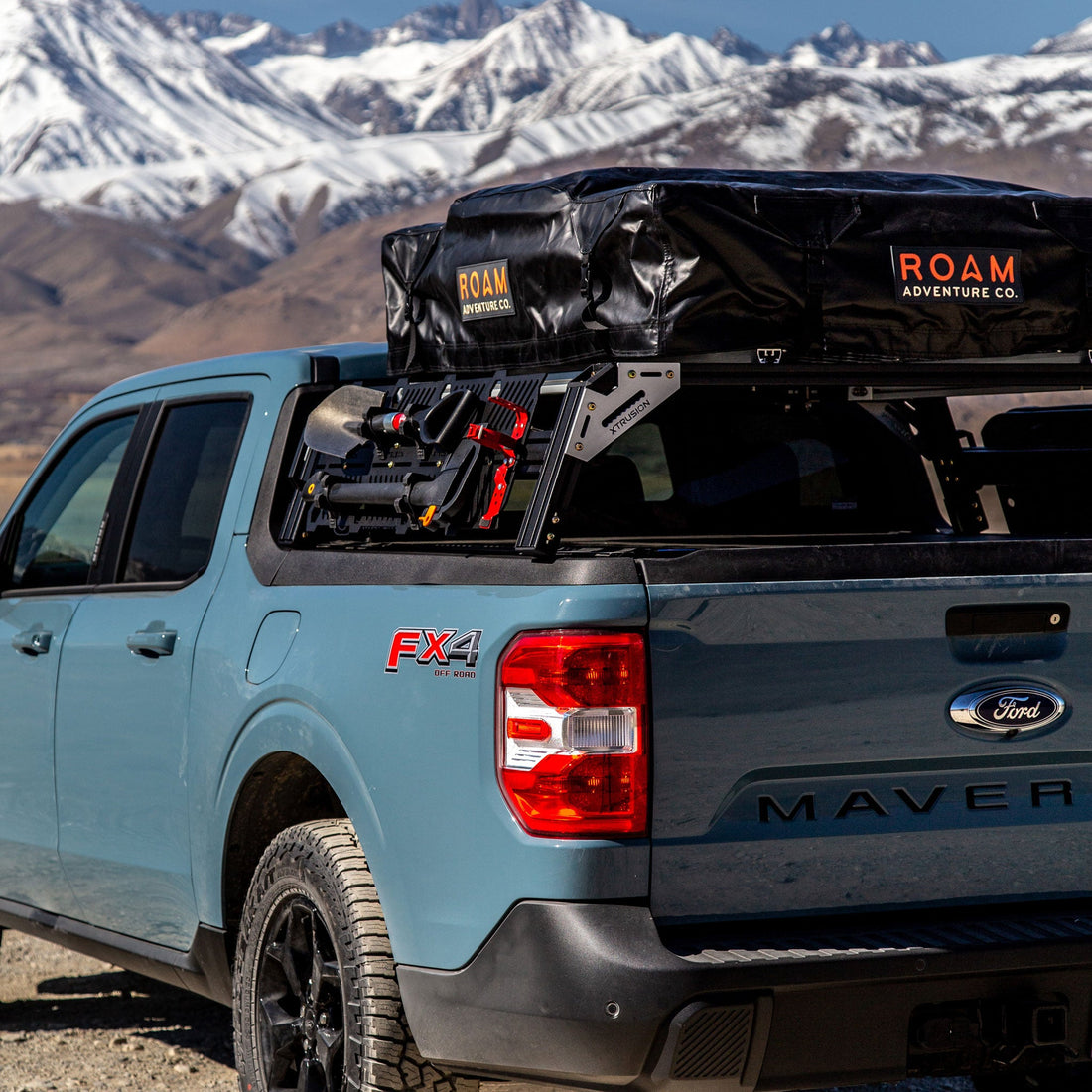 Ford Maverick FX4 with xtrusion overland bed rack and molle panels loaded with ROAM RTT, Shovel, ax, and fire extinguisher mount.