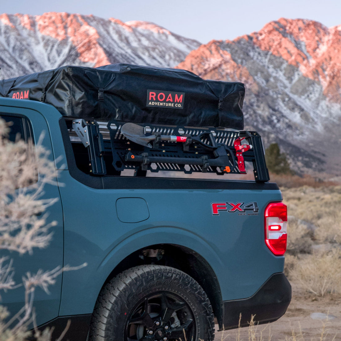 Maverick FX4 with 13 inch high xtrusion overland bed rack and molle panels loaded with ROAM RTT, Shovel, ax, and fire extinguisher mount  