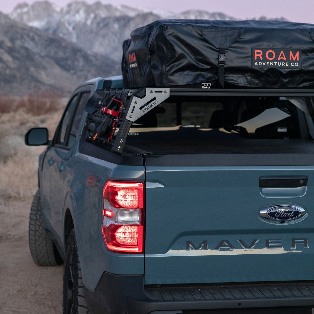 Maverick FX4 with 13 inch high xtrusion overland bed rack and molle panels loaded with ROAM RTT, Shovel, ax, and fire extinguisher mount  