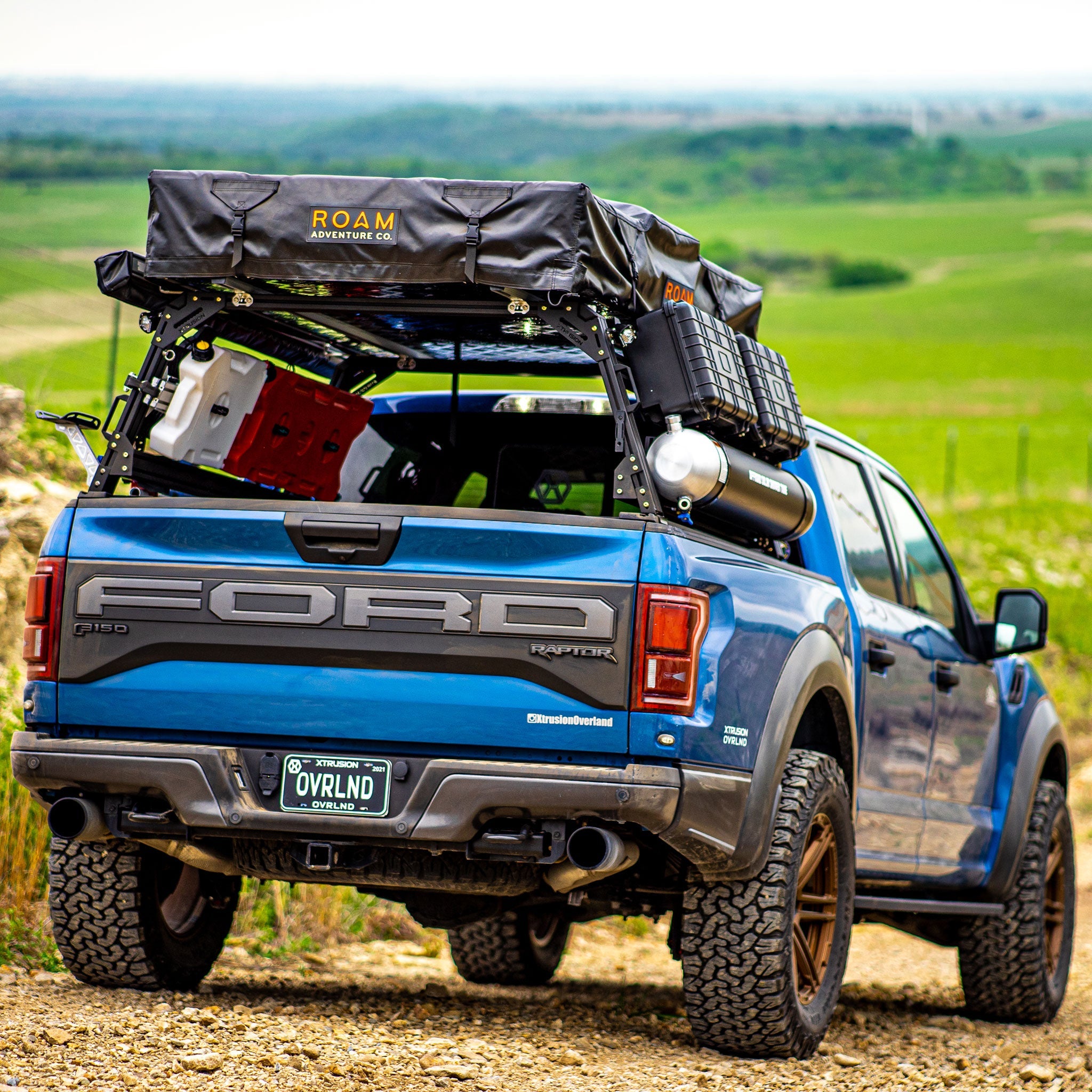 Gen 2 Ford Raptor Extrusion Overland Bed Rack with Rotopax’s mounted, Molle panels, Roof top tent, awning, travel cases, and Pressurized solar water tank.