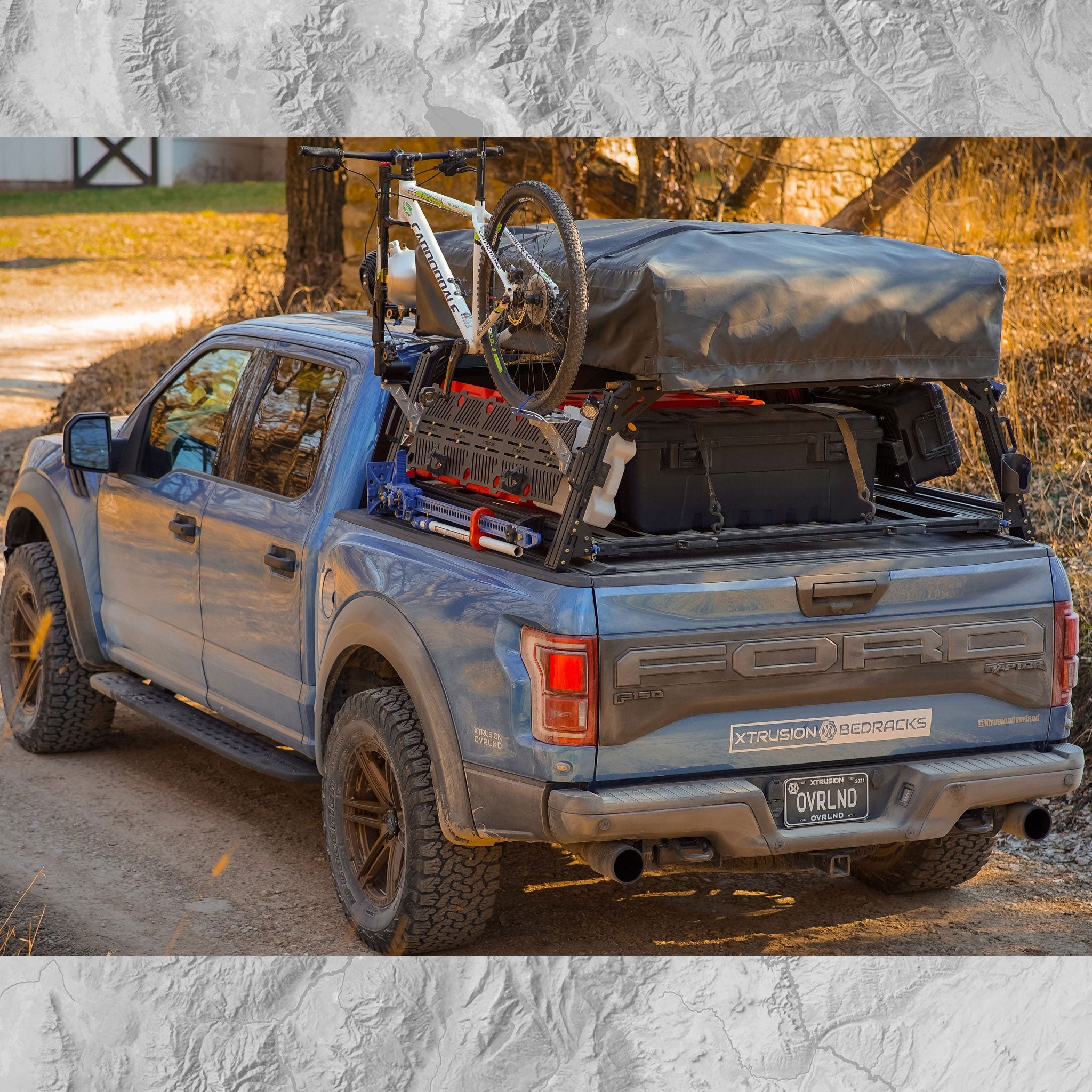 Ford Raptor Extrusion Overland Bed Rack with Hi-lift mounted, Rotopax’s mounted, Molle panels, Mountain Bike, Roof top tent, and Pressurized solar water tank.