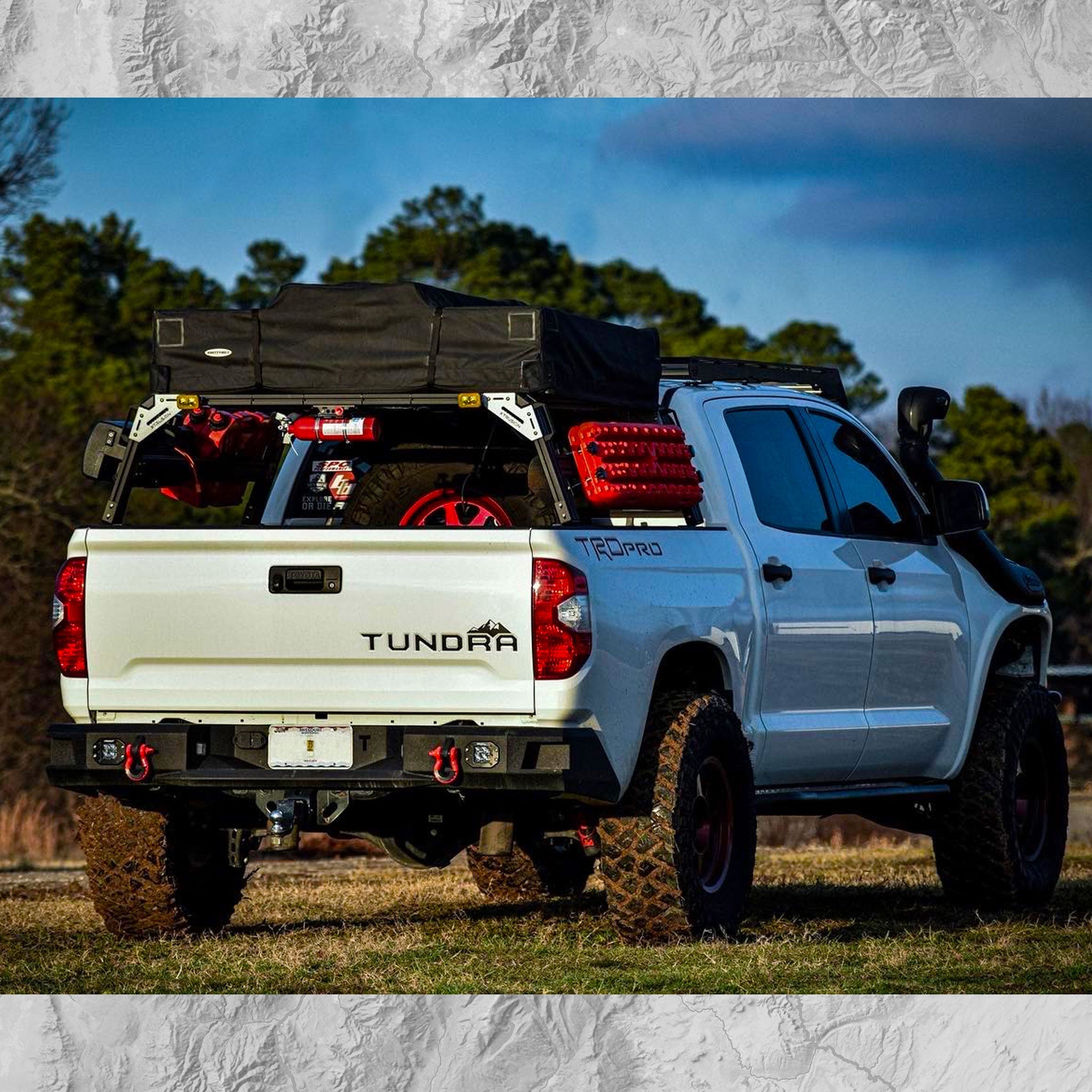Toyota Tundra with Xtrusion Overland XTR1 Bed Rack with mounted traction boards, roof top tent, water tank, and RotoPax.